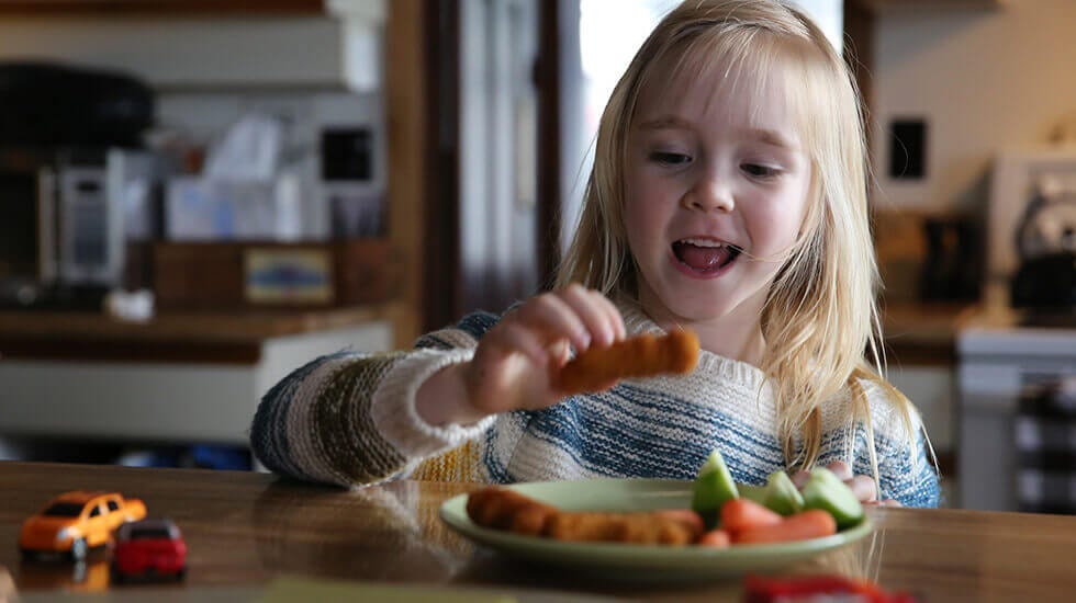 girl eating chicken nuggets