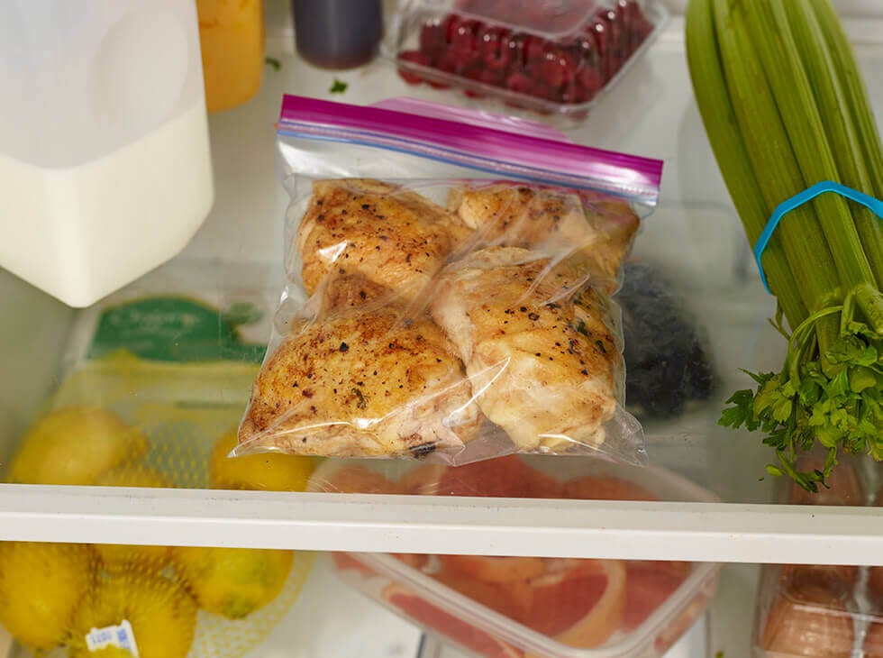 Chicken in a Ziploc bag being stored in refrigerator