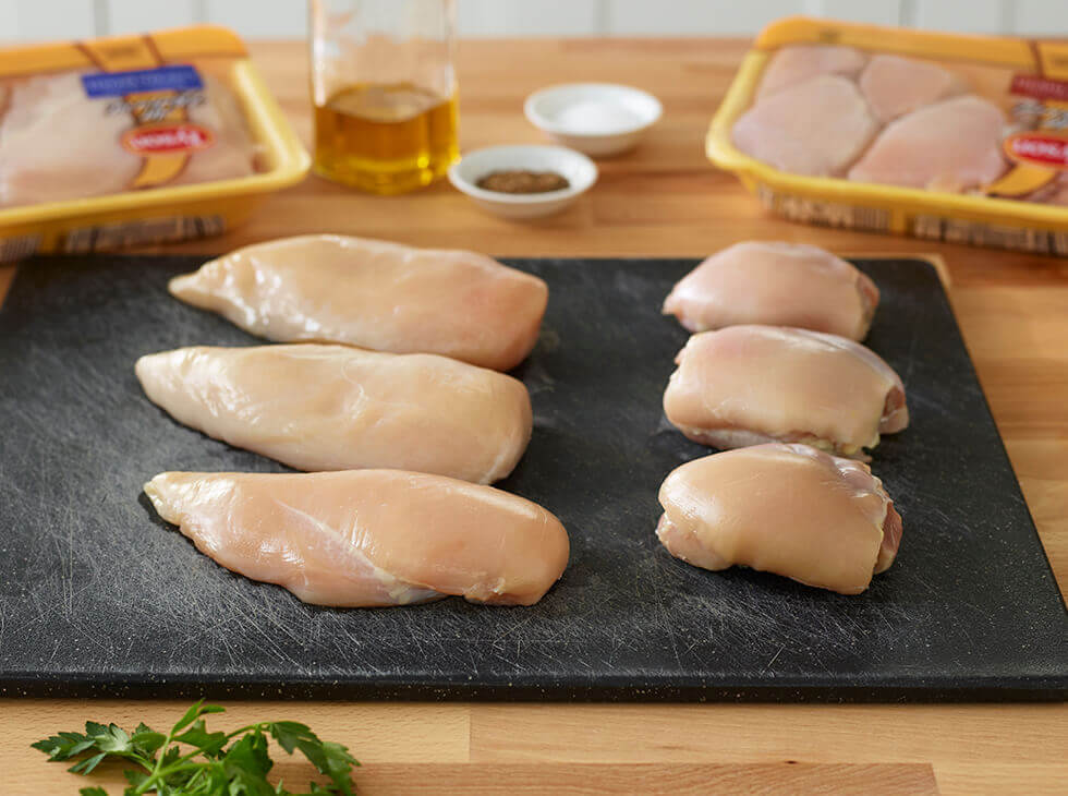 Chicken breast on a black cutting board