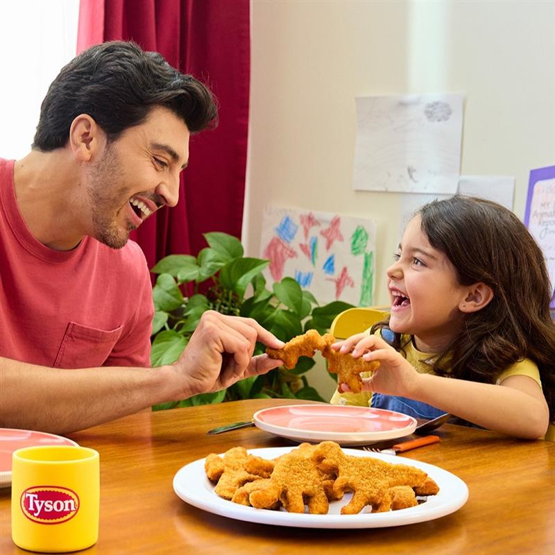 Dad and Daughter eating Tyson Dino Nuggets at Kitchen Table