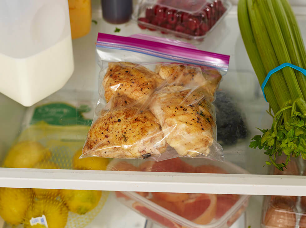 Chicken in a Ziploc bag being stored in refrigerator